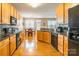 Spacious kitchen flows into breakfast nook with wood cabinets, granite countertops at 7554 Coastal Way, Huntersville, NC 28078