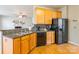 Open kitchen boasts granite counters, stainless steel appliances, and wood cabinets at 7554 Coastal Way, Huntersville, NC 28078