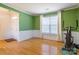 Bright room featuring hardwood floors, wainscoting, a large window and exercise equipment at 7554 Coastal Way, Huntersville, NC 28078