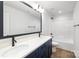 Modern bathroom with double sink vanity, sleek black fixtures, and a bathtub-shower combination at 8007 Willhill Rd, Mint Hill, NC 28227