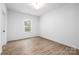 A bright, empty bedroom with natural light, neutral walls, and modern flooring at 8007 Willhill Rd, Mint Hill, NC 28227
