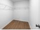 Walk-in closet featuring wire shelving, wood-look floors, and ample storage space at 8007 Willhill Rd, Mint Hill, NC 28227