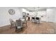 Modern kitchen featuring white cabinets, stainless steel appliances, a breakfast bar, and adjacent dining area at 8007 Willhill Rd, Mint Hill, NC 28227