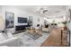 Bright living room with modern decor, a large rug, hardwood floors, and an open view to the kitchen area at 8007 Willhill Rd, Mint Hill, NC 28227