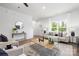 Spacious living room featuring hardwood floors, neutral furniture, and a large window, creating an inviting atmosphere at 8007 Willhill Rd, Mint Hill, NC 28227
