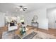 Inviting living room featuring hardwood floors, neutral furniture, and an open view to the kitchen and dining areas at 8007 Willhill Rd, Mint Hill, NC 28227