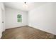 Bedroom with wood flooring and large window letting in natural light at 8021 Willhill Rd, Mint Hill, NC 28227