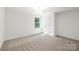 Bright bedroom featuring plush carpet and a window to provide natural light at 8021 Willhill Rd, Mint Hill, NC 28227