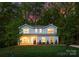 Charming two-story gray home with a manicured front lawn and brick foundation under the porch in a wooded lot at 8021 Willhill Rd, Mint Hill, NC 28227