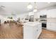 Open concept kitchen with a large island, stainless appliances, and sight lines to the living room at 8021 Willhill Rd, Mint Hill, NC 28227