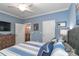 This bedroom features blue walls, neutral carpet and a view into the dining room at 8518 Christalina Ln, Denver, NC 28037