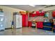 Well-organized garage with custom red cabinets and a workbench, providing ample storage and functionality at 8518 Christalina Ln, Denver, NC 28037