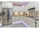 Bright kitchen with stainless steel refrigerator, decorative backsplash, and stylish white cabinets at 8518 Christalina Ln, Denver, NC 28037