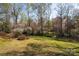 Spacious and well-maintained backyard with plenty of mature trees at 916 Rollingwood Dr, Mount Holly, NC 28120