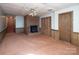 Finished basement featuring a fireplace, storage and paneled walls at 916 Rollingwood Dr, Mount Holly, NC 28120