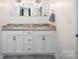 Bathroom featuring double vanity, marble countertop, modern fixtures, and gray flooring at 916 Rollingwood Dr, Mount Holly, NC 28120