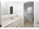 Bright bathroom with white cabinets, vanity, and beige countertops at 916 Rollingwood Dr, Mount Holly, NC 28120