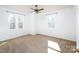 Bright bedroom featuring two windows and neutral carpet at 916 Rollingwood Dr, Mount Holly, NC 28120