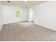Bright bedroom features neutral carpet, ceiling fan, and windows for natural light at 916 Rollingwood Dr, Mount Holly, NC 28120
