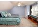Cozy bedroom with window seat, sloped ceilings, and relaxing blue walls at 916 Rollingwood Dr, Mount Holly, NC 28120