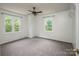 Bedroom featuring carpet, two windows for natural light, and a ceiling fan at 916 Rollingwood Dr, Mount Holly, NC 28120