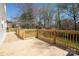 Wide angle view of wood deck and railing with mature trees in the backyard at 916 Rollingwood Dr, Mount Holly, NC 28120