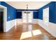 Elegant dining room with hardwood floors, modern chandelier, and French doors to the outside at 916 Rollingwood Dr, Mount Holly, NC 28120