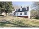 Charming home with a manicured lawn, dormer windows, and a blue door at 916 Rollingwood Dr, Mount Holly, NC 28120