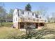 Back of the home with deck and patio overlooking the landscaped yard at 916 Rollingwood Dr, Mount Holly, NC 28120