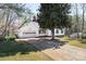Well-maintained home with a two-car garage, long driveway, and mature trees at 916 Rollingwood Dr, Mount Holly, NC 28120