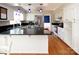 Kitchen with white cabinets, stainless steel appliances, granite counters and wood floors at 916 Rollingwood Dr, Mount Holly, NC 28120