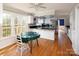 Bright eat-in kitchen featuring white cabinetry, granite countertops, stainless steel appliances and hardwood floors at 916 Rollingwood Dr, Mount Holly, NC 28120