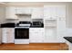 A full view of the stove, microwave, and cabinets in this kitchen with granite counters at 916 Rollingwood Dr, Mount Holly, NC 28120