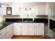 This kitchen features white cabinets, granite countertops, and stainless steel appliances at 916 Rollingwood Dr, Mount Holly, NC 28120