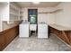 Bright laundry room with built-in shelves, linoleum floor, and natural light at 916 Rollingwood Dr, Mount Holly, NC 28120