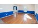 Bright living room with hardwood floors, decorative wall trim, and ample natural light at 916 Rollingwood Dr, Mount Holly, NC 28120