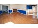 Spacious living room featuring hardwood floors, a brick fireplace, and open doorways at 916 Rollingwood Dr, Mount Holly, NC 28120