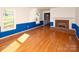 Inviting living room with hardwood floors, a cozy brick fireplace, and bright windows at 916 Rollingwood Dr, Mount Holly, NC 28120
