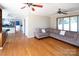 Open-concept living room with hardwood floors and a seamless transition to the kitchen at 916 Rollingwood Dr, Mount Holly, NC 28120