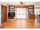 Open-concept living room with hardwood floors, built-in bookshelves, and access to outdoor space at 916 Rollingwood Dr, Mount Holly, NC 28120