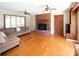 Spacious living room boasts a brick fireplace, hardwood floors and natural light at 916 Rollingwood Dr, Mount Holly, NC 28120