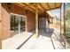 Covered patio space with brick siding and sliding door access to the home at 916 Rollingwood Dr, Mount Holly, NC 28120