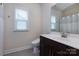 Bathroom features a toilet, vanity with sink, window, and shower with curtain at 938 Moose Trl, Matthews, NC 28104