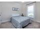 Carpeted bedroom with ample natural light and simple decor at 938 Moose Trl, Matthews, NC 28104
