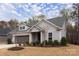 Charming one-story home featuring gray siding, a two-car garage and a well-manicured lawn at 938 Moose Trl, Matthews, NC 28104