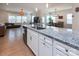 Spacious open floor plan with a large kitchen island featuring granite countertops and a stainless steel sink at 938 Moose Trl, Matthews, NC 28104