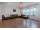 Comfortable living room with hardwood floors, neutral tones, and plenty of natural light from large windows at 938 Moose Trl, Matthews, NC 28104