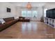 Bright living room featuring hardwood floors, ample natural light, and a comfortable seating area at 938 Moose Trl, Matthews, NC 28104