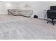 Large carpeted living room with comfortable sectional sofa and adjacent staircase at 938 Moose Trl, Matthews, NC 28104