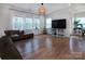 Bright living room featuring hardwood floors, ample natural light, and a comfortable seating area at 938 Moose Trl, Matthews, NC 28104